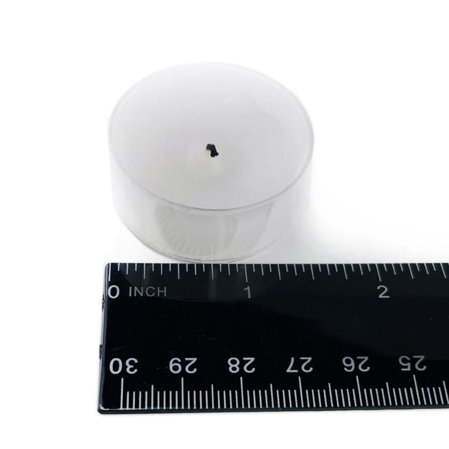 Tealight candle that fits in hole, next to a ruler for size  reference