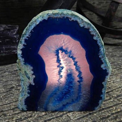 Agate Candle Holder shown here in blue with the candle lit