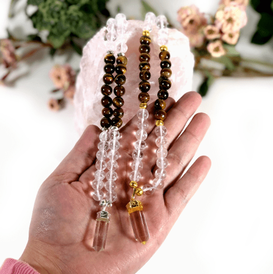 mala necklaces in hand for size reference 
