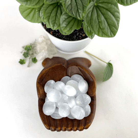 selenite palm stones with decorations in the background