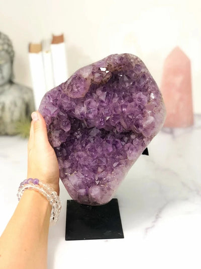 Amethyst Crystal Cluster on Metal Stand  with a hand for size reference