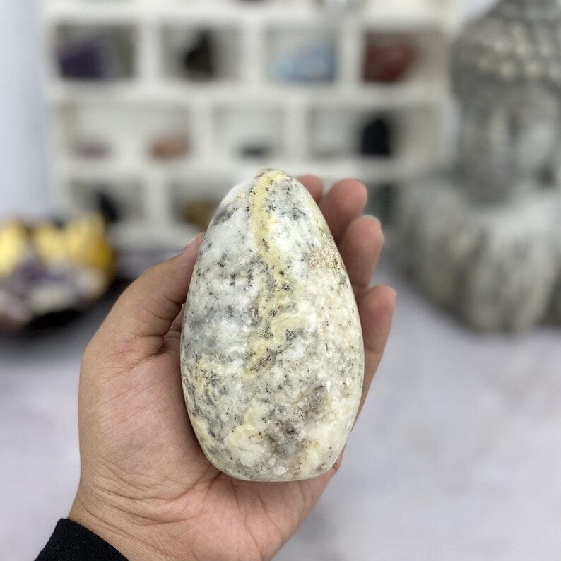 Dendritic Opal Freeform Cut Base in a hand for size reference