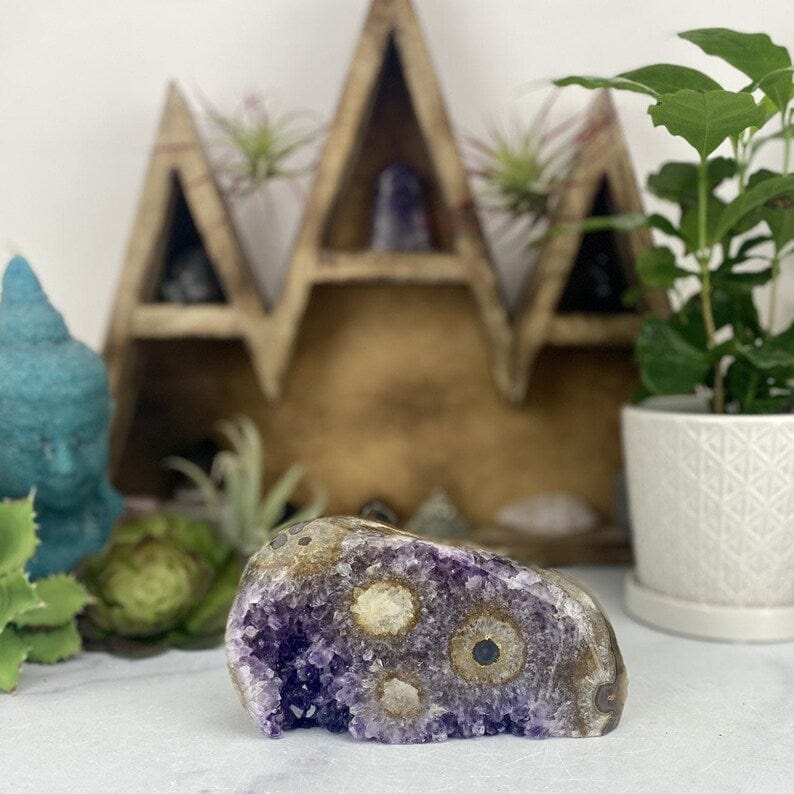 Amethyst Stalactite Freeform Cut Base Crystal on display