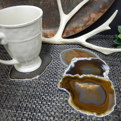 4 brown/black agate coasters with silver electroplate edging with cup used as a coaster