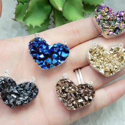 Mystic Druzy Heart Double Bail Pendants in a hand for size reference