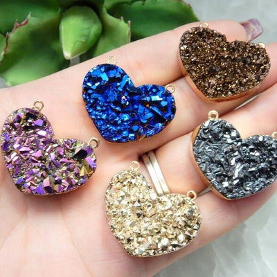 Mystic Druzy Heart Double Bail Pendants in a hand in assorted colors