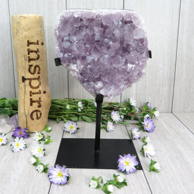 amethyst on stand with decorations in the background