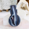 Agate Snowman Crystal Mini-Statue leaning against selenite moon for reference.