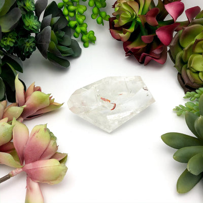 crystal quartz with decorations in the background