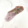 Seven Mineral Semi Polished Crystal Stone on marble background for reference.