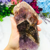 Seven Mineral Semi Polished Crystal Stone on hand for reference.