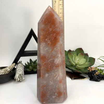 hematite point with decorations in the background