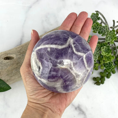 amethyst sphere with decorations in the background