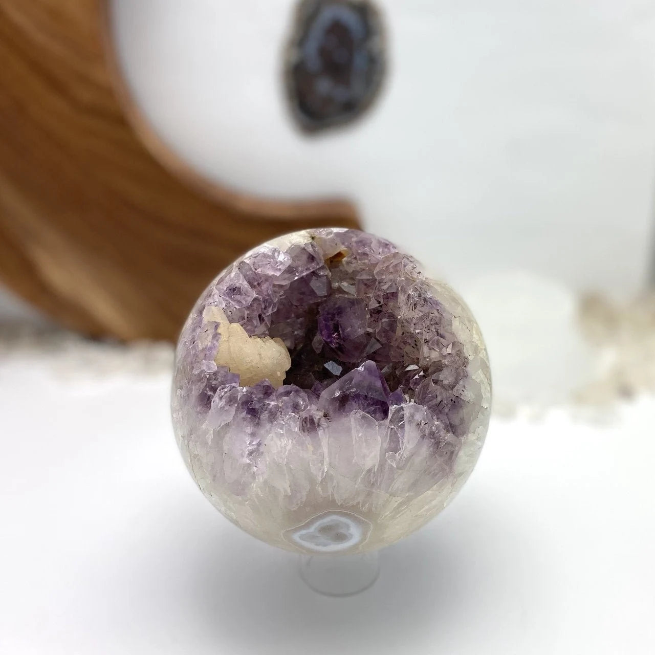 amethyst sphere with decorations in the background