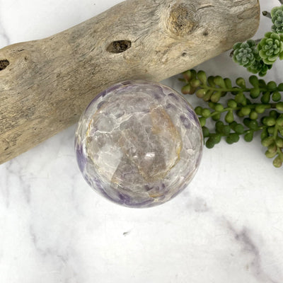 amethyst sphere with decorations in the background