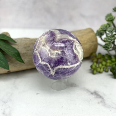 amethyst sphere with decorations in the background