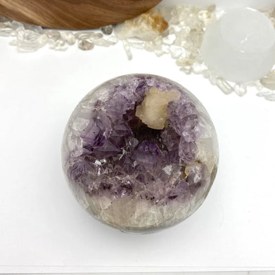 amethyst sphere with decorations in the background