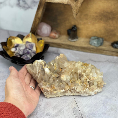 Hematoid Quartz Cluster with a hand for size reference