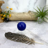 Dyed Blue Agate Crystal Polished Sphere on acrylic sphere stand for reference.