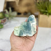 Raw Fluorite Crystal Stone on hand for size reference.