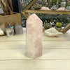 Rose Quartz Polished Point Tower Cut Base on wood surface for reference.