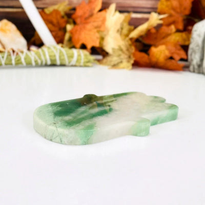 Green and White Quartz Hamsa Hand Stone Slice at an angle showing thickness