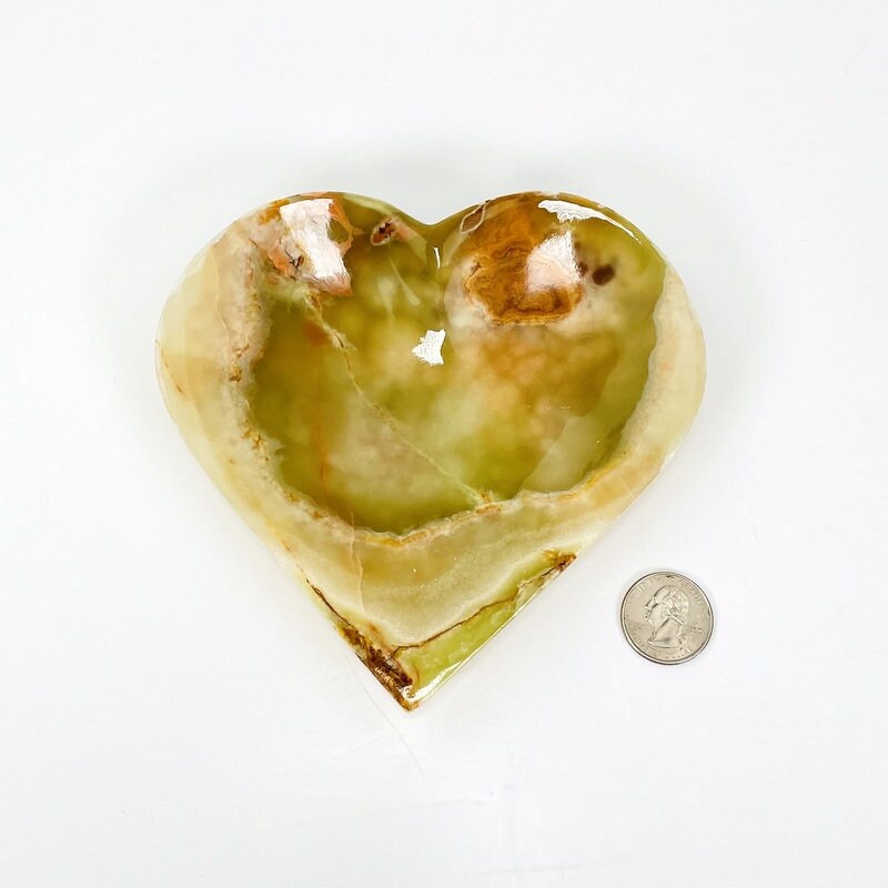 Green Mexican Onyx Heart Bowl next to a quarter for size reference
