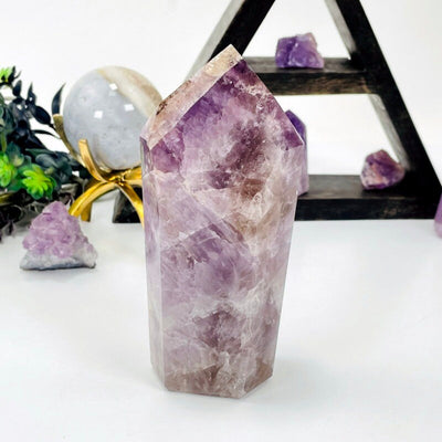 amethyst point with decorations in the background