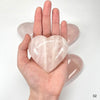 Rose Quartz Crystal Polished Hearts on hand for size reference 