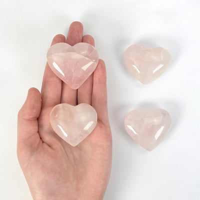 rose quartz heart with decorations in the background