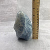 Blue Calcite Flame Point next to ruler for size reference.