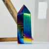 Side view of Rainbow Titanium Agate Crystal Point on white base for reference.