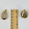 Smokey Quartz Semi Polished Gold Electroplated Pendants next to ruler for size reference.