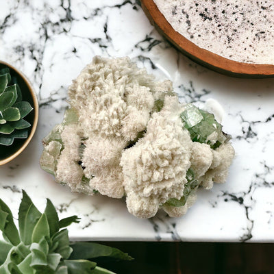 Zeolite with Green Apophyllite - Crystal Cluster - High Quality on marble countertop with succulents in background