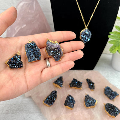 Mystic Blue Titanium Crystal Cluster Gold Plated Pendant - You Choose three pendants in hand with other pendants in background