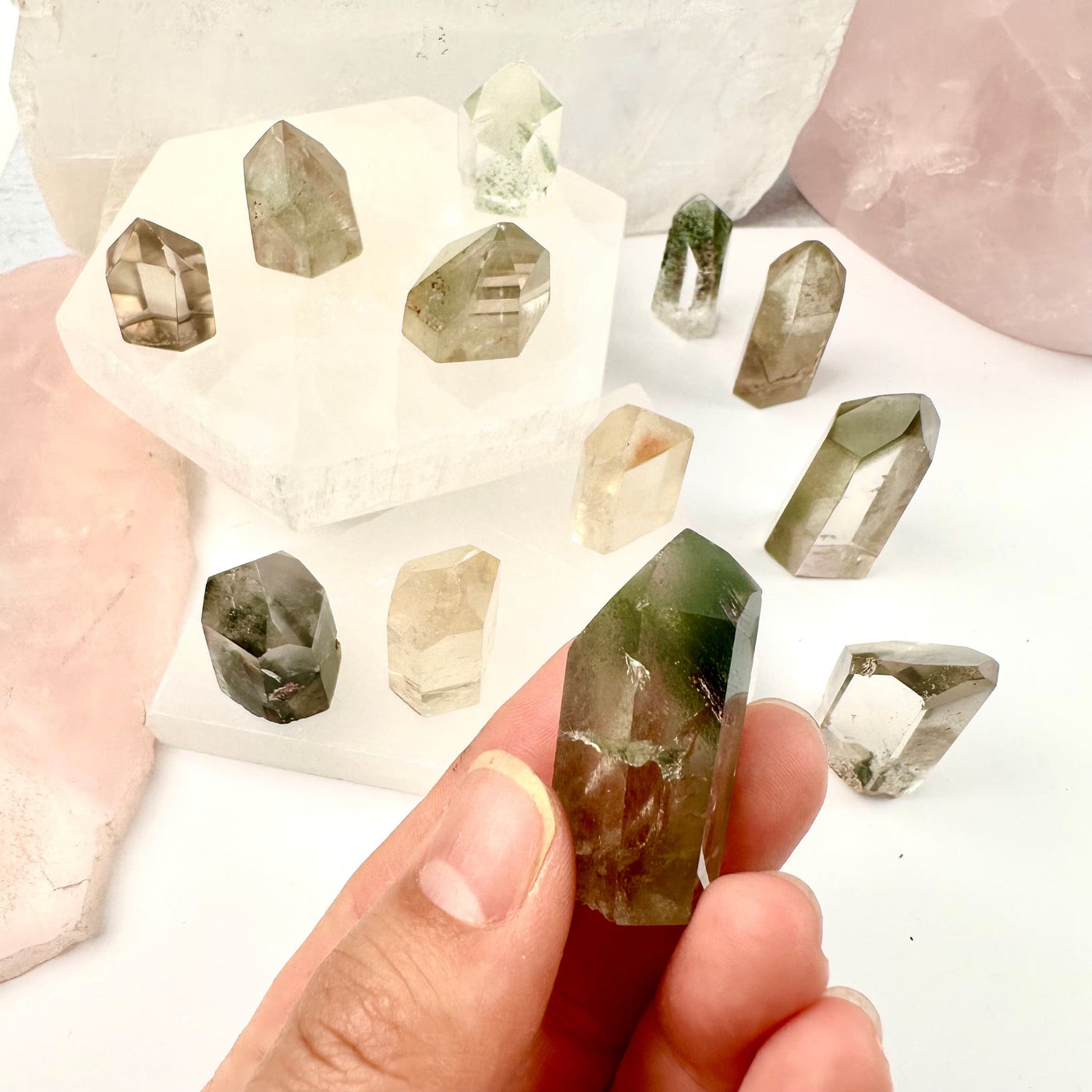 Crystal Quartz Points with Inclusions - Small Crystals - You Choose variant 8 in hand for size reference with other points in the background