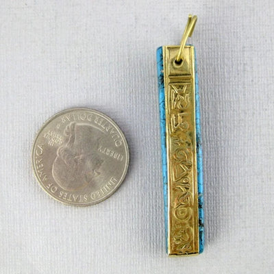 Blue Howlite and Brass Bar Pendant next to a quarter for size reference