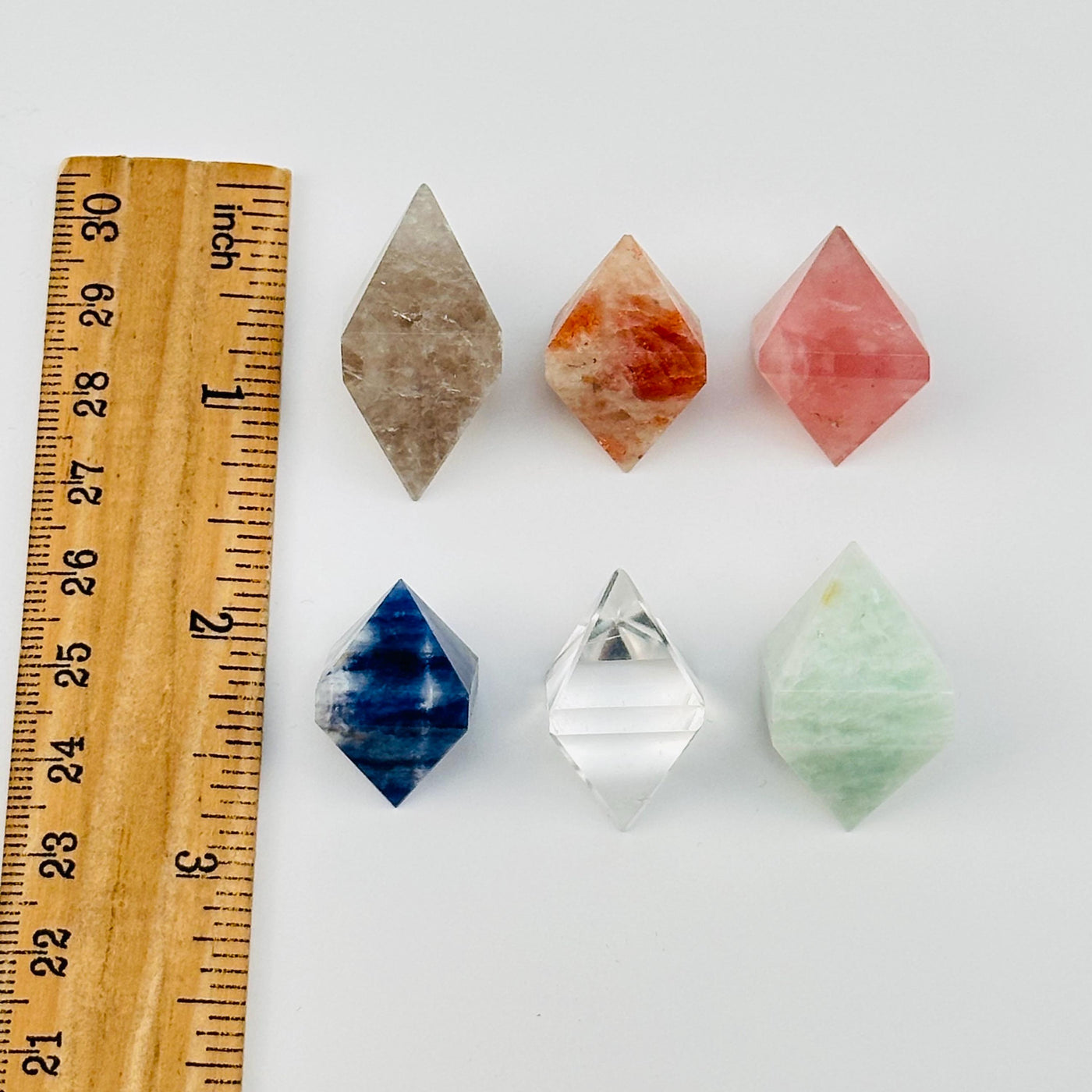 crystal diamonds next to a ruler for size reference 