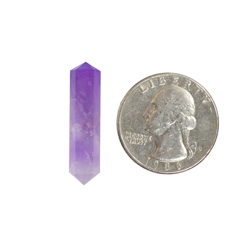 amethyst double terminated point next to a quarter for size reference