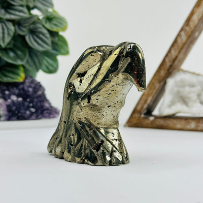angled shot of Pyrite eagle head with decorations in the background