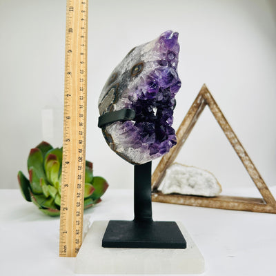 amethyst with stand next to a ruler for size reference