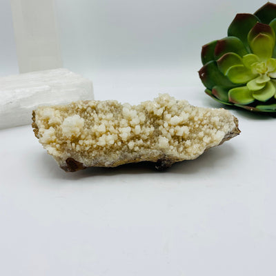calcite stalactite with decorations in the background