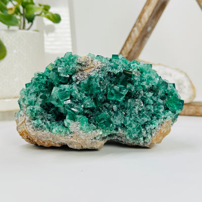 fluorite formation cluster with decorations in the background