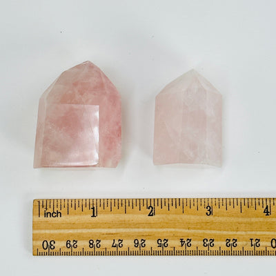 rose quartz polished points next to a ruler for size reference