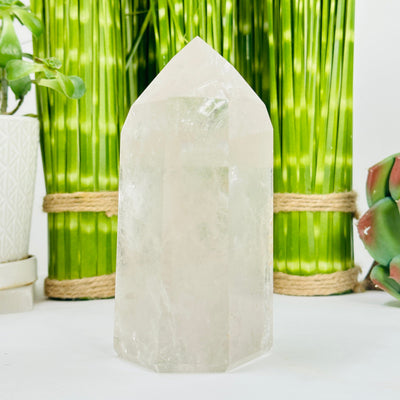 crystal quartz point with decorations in the background