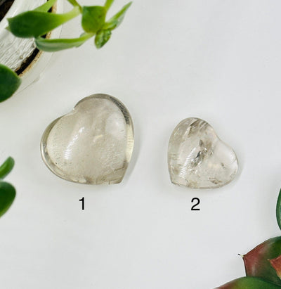 Crystal quartz hearts with decorations in the background