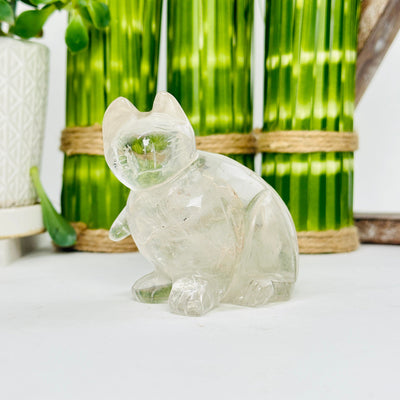 crystal quartz cat statue with decorations in the background