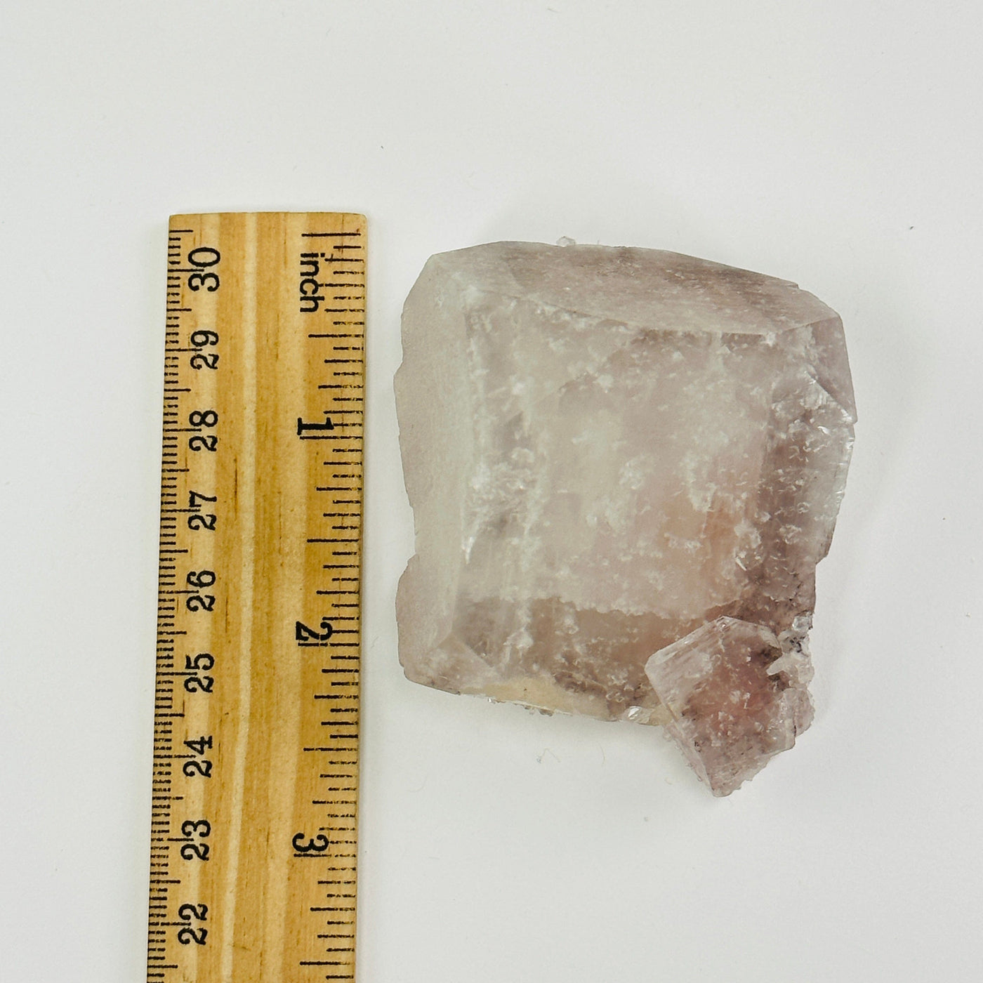 apophyllite cluster next to a ruler for size reference