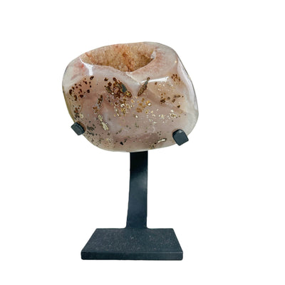amethyst geode with metal stand on white background