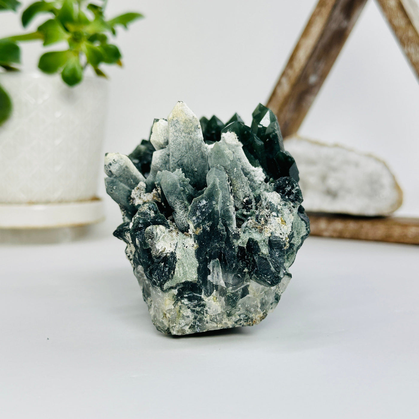 hedenbergite cluster with decorations in the background